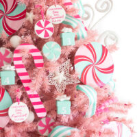 middle view of decorated pink christmas tree with peppermint ornaments