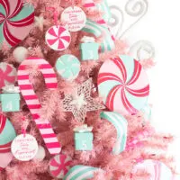 middle view of decorated pink christmas tree with peppermint ornaments