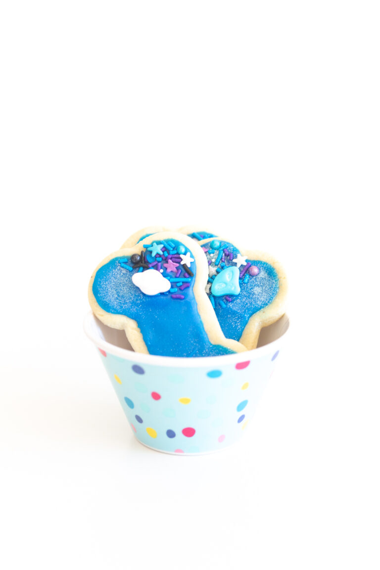 galaxy themed blue alien dog bone cookies in a cute small polkadot bowl