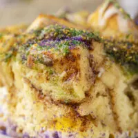 close up side view image of a piece of bubble up king cake on a white plate