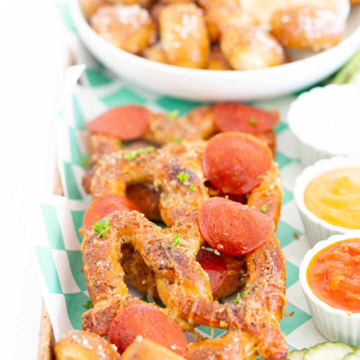 view of pizza pretzels on a football snacking board