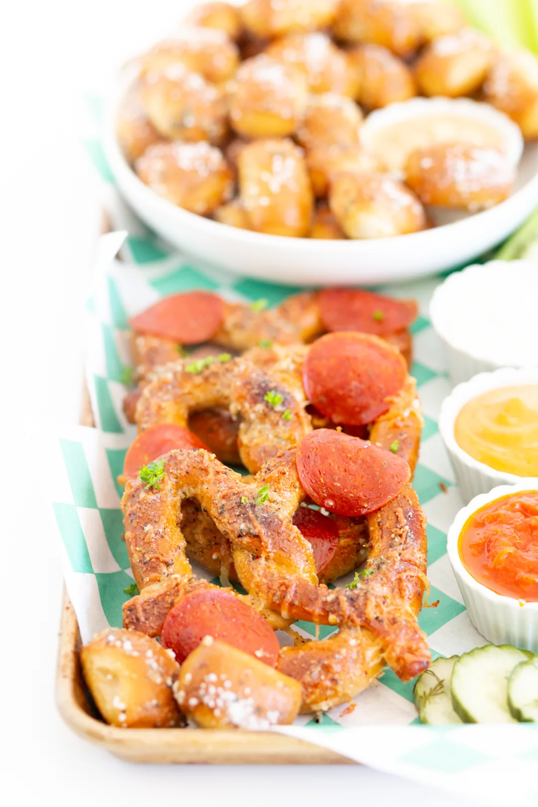 view of pizza pretzels on a football snacking board