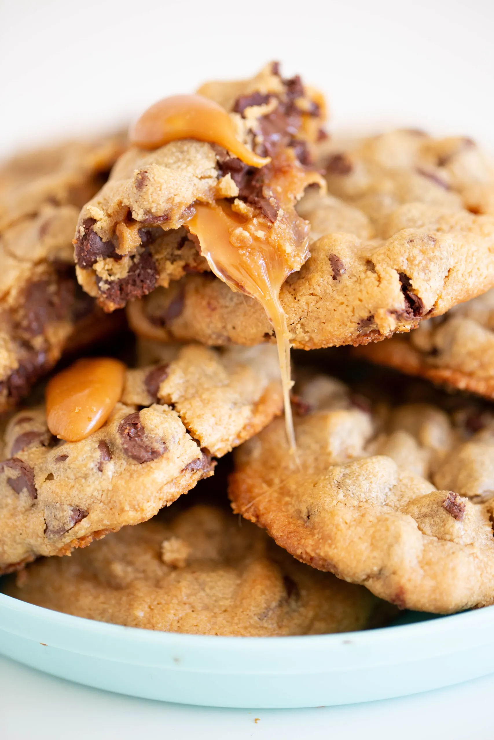 plate of chocolate chip caramel cookies with caramel oozing out