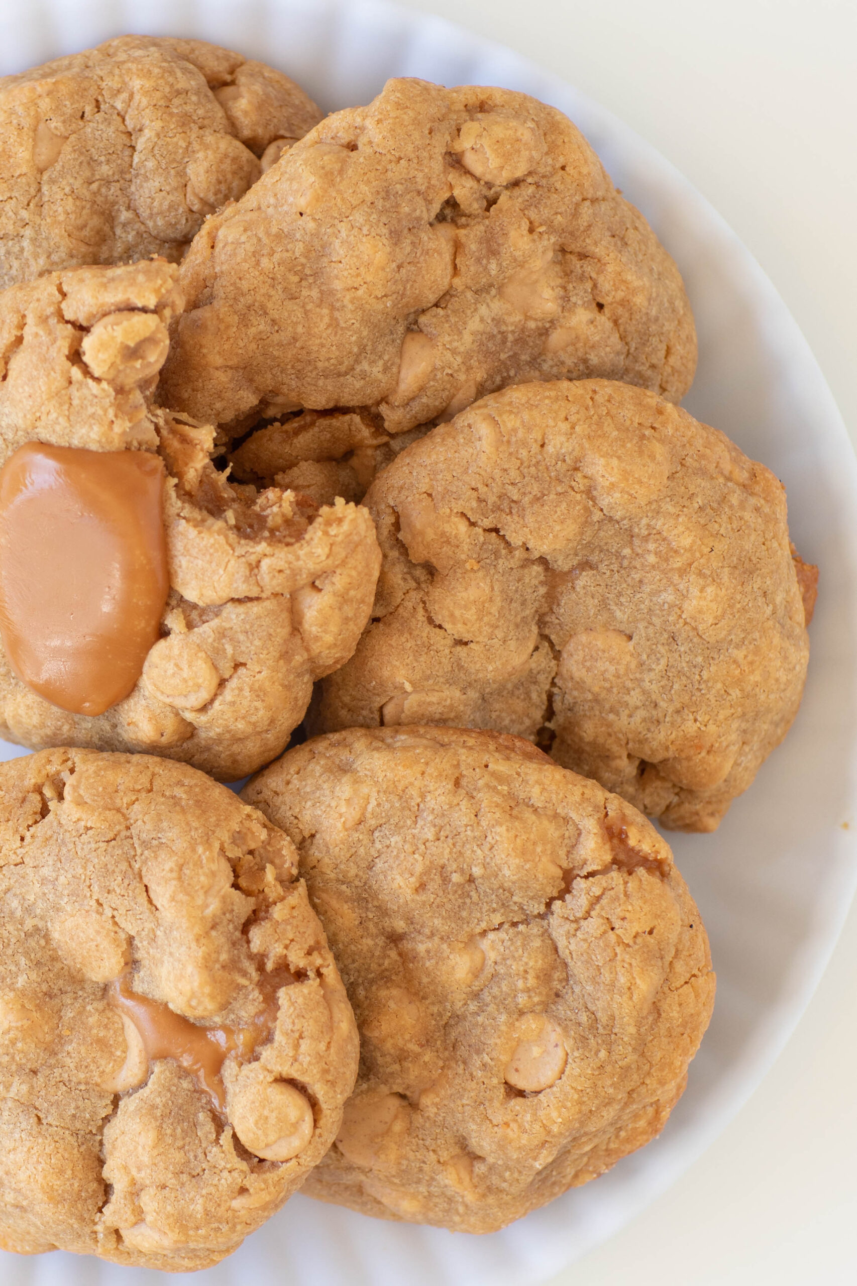 small plate of thick peanut butter cookies stuffed with caramel