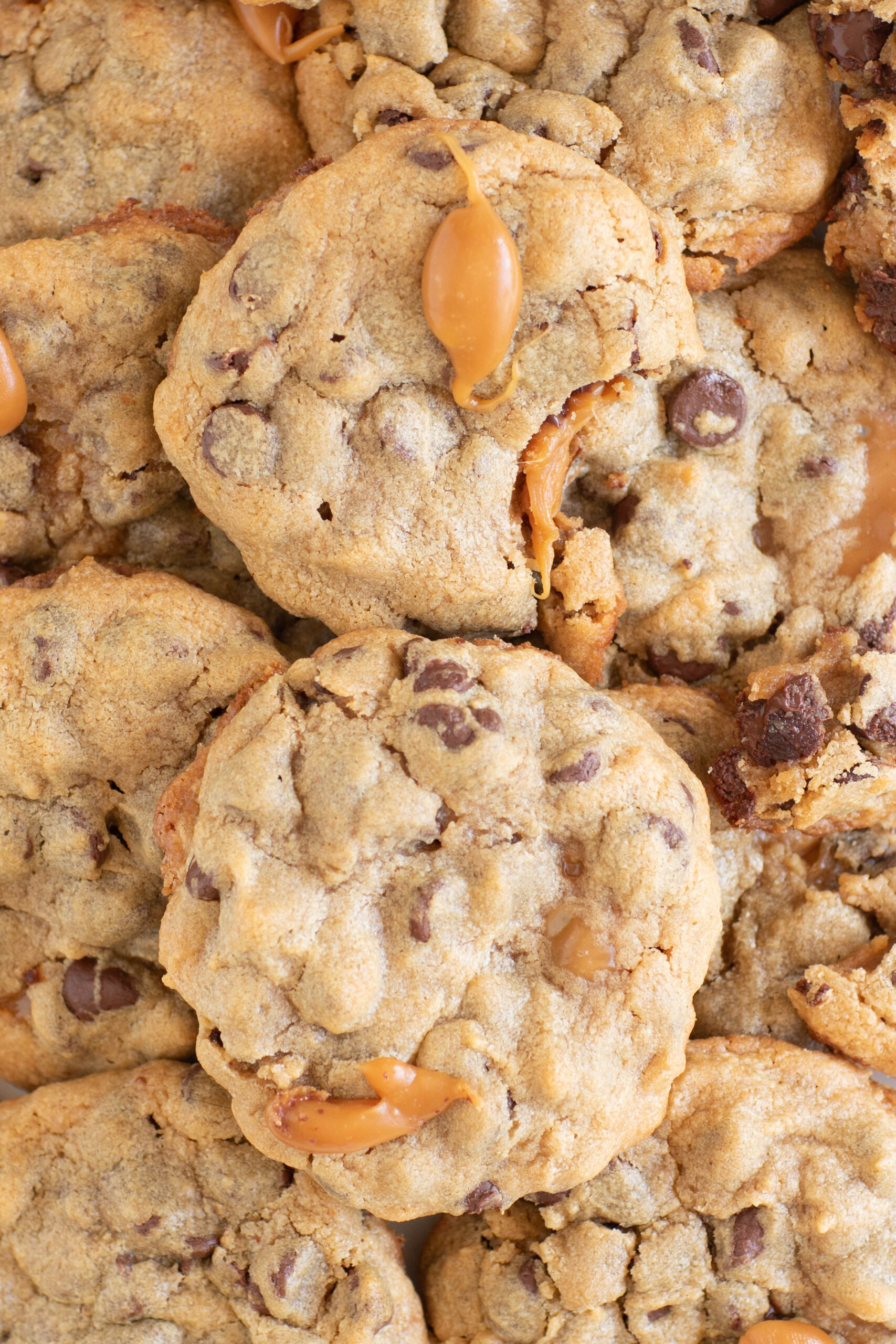 over the top view of chocolate chip cookies with caramel oozing out