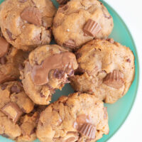 small teal plate filled with chunky peanut butter cup cookies