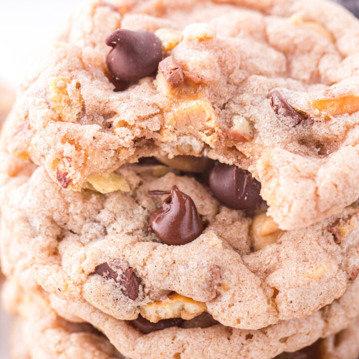 angled down view of stack of kitchen sink cookies with a bite taken out of the cookie on top