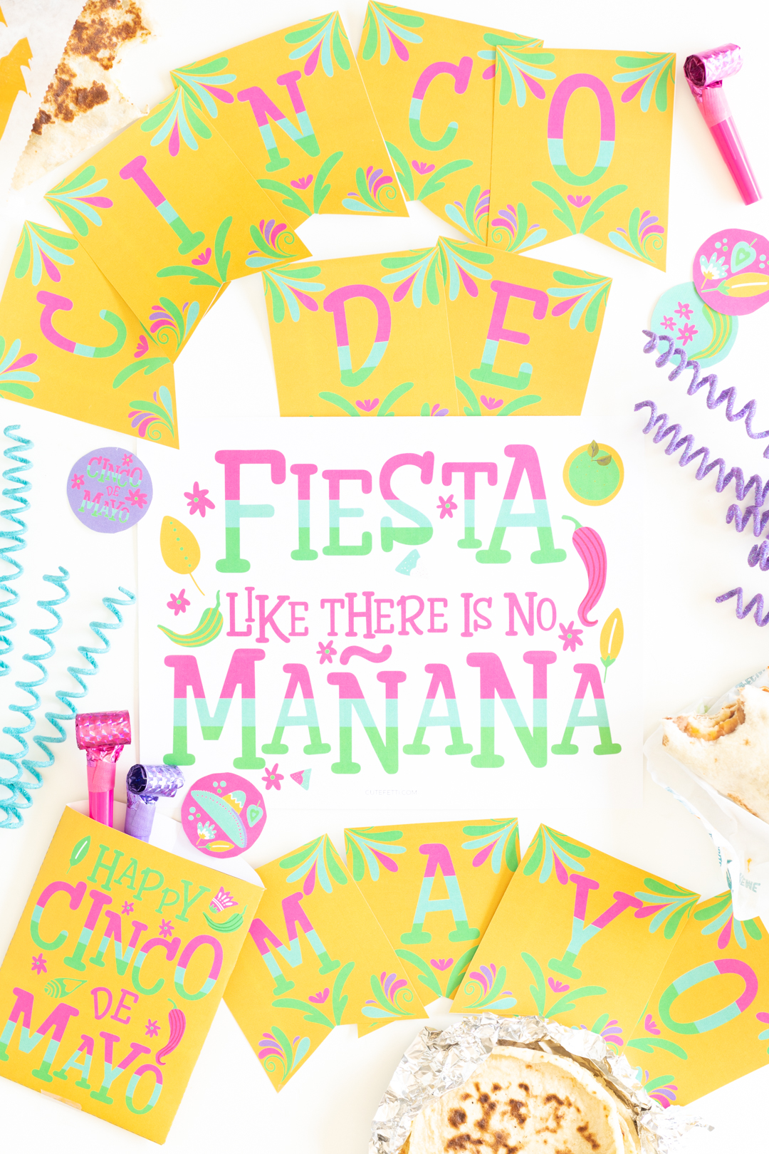 sign that says fiesta like there is no manana set among other party supplies like a cinco de mayo banner, party blowers and Mexican food