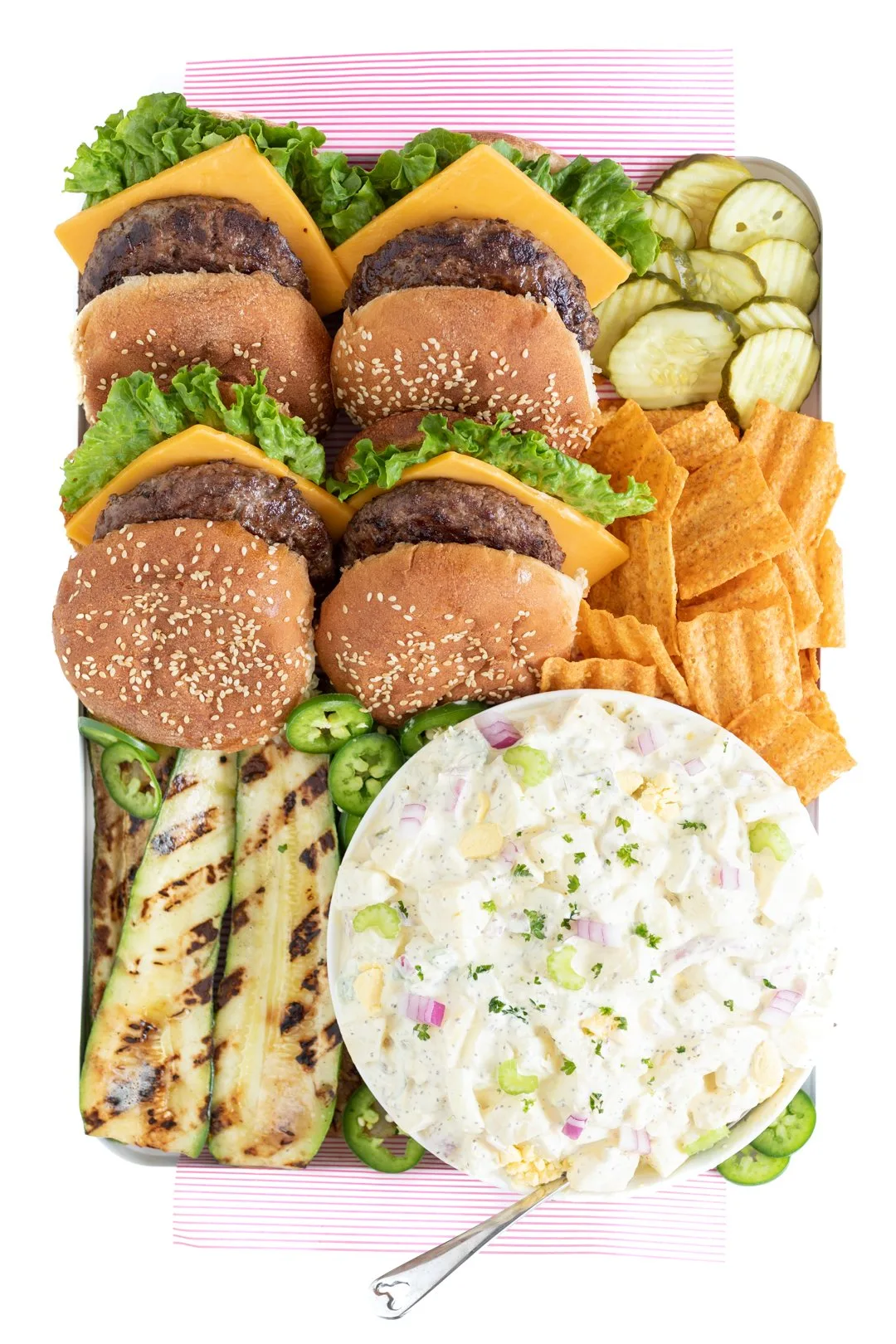 grilled burgers and traditional potato salad served on a tray