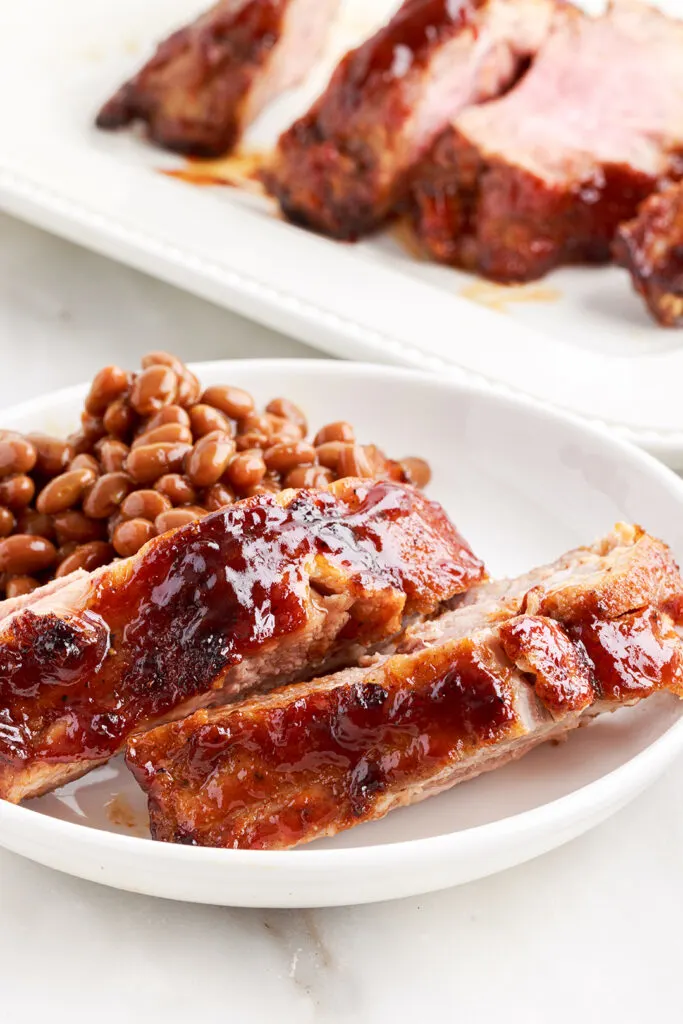 plated bbq ribs served with baked beans
