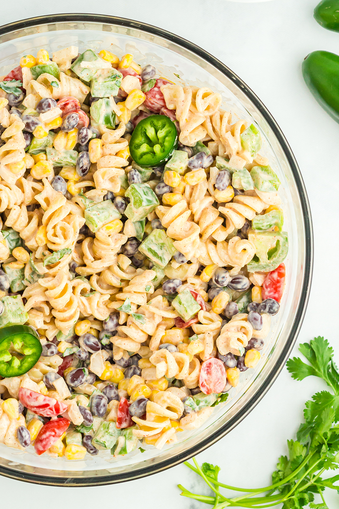up close over the top pasta salad photo with sliced jalapeños to decorate