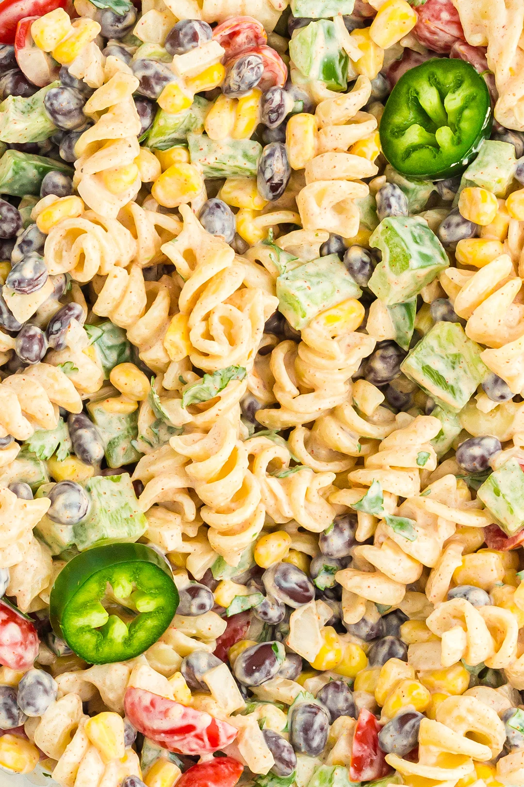 up close view of southwest pasta salad with jalapeno slices as garnish