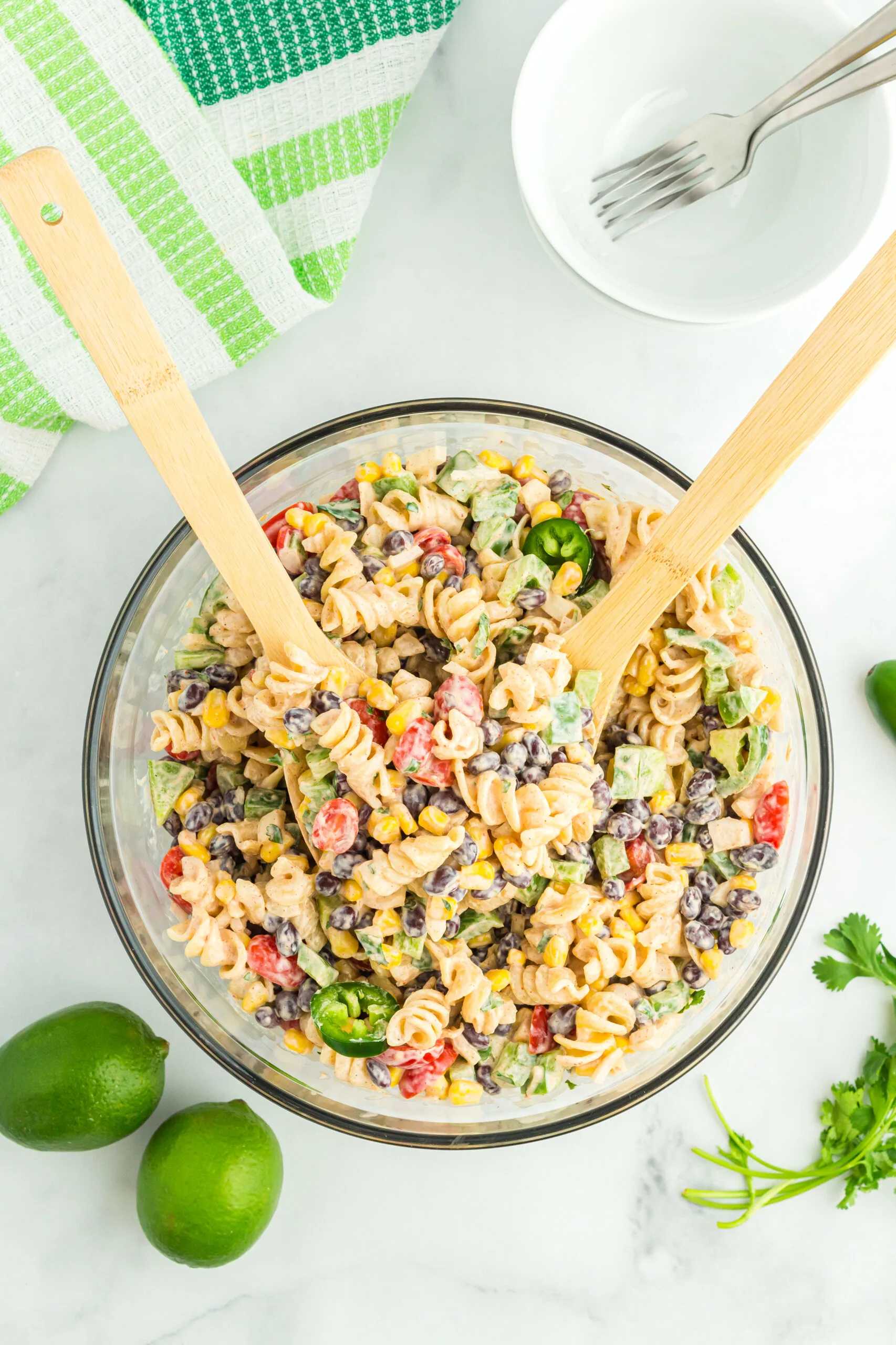 over the top southwest pasta salad with serving fork and spoon inside