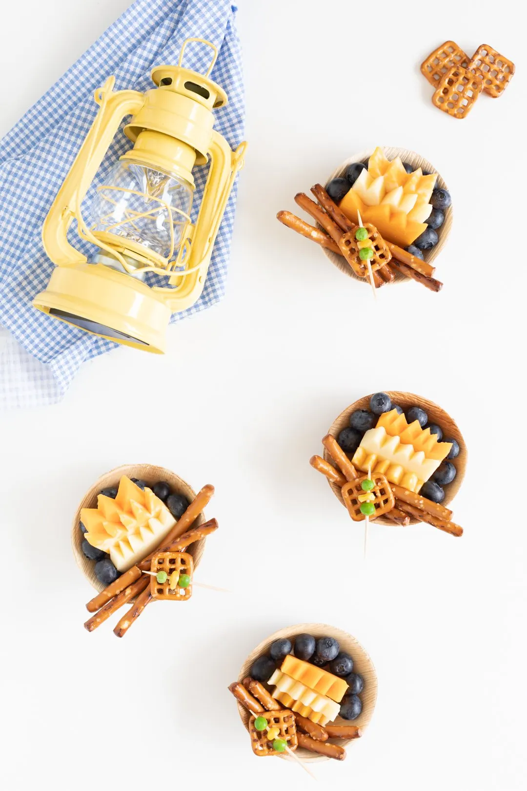 over the top photo of campfire themed snacks for kids. multiple cheese layers trimmed to look like a fire.