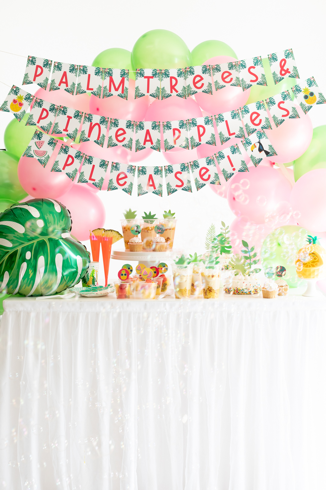 tropical party table with bubbles being blown
