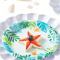 fruit topped star cookie on a tropical party plate