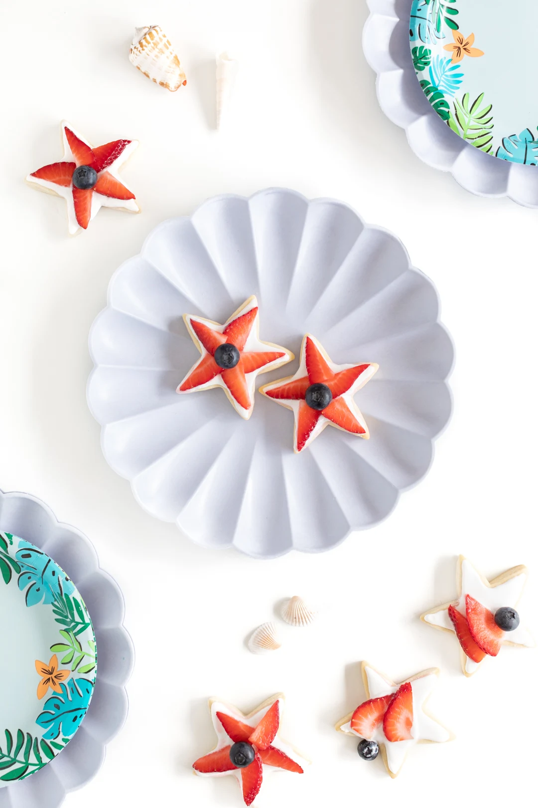 shell plate with two star-shaped strawberry topped sugar cookies