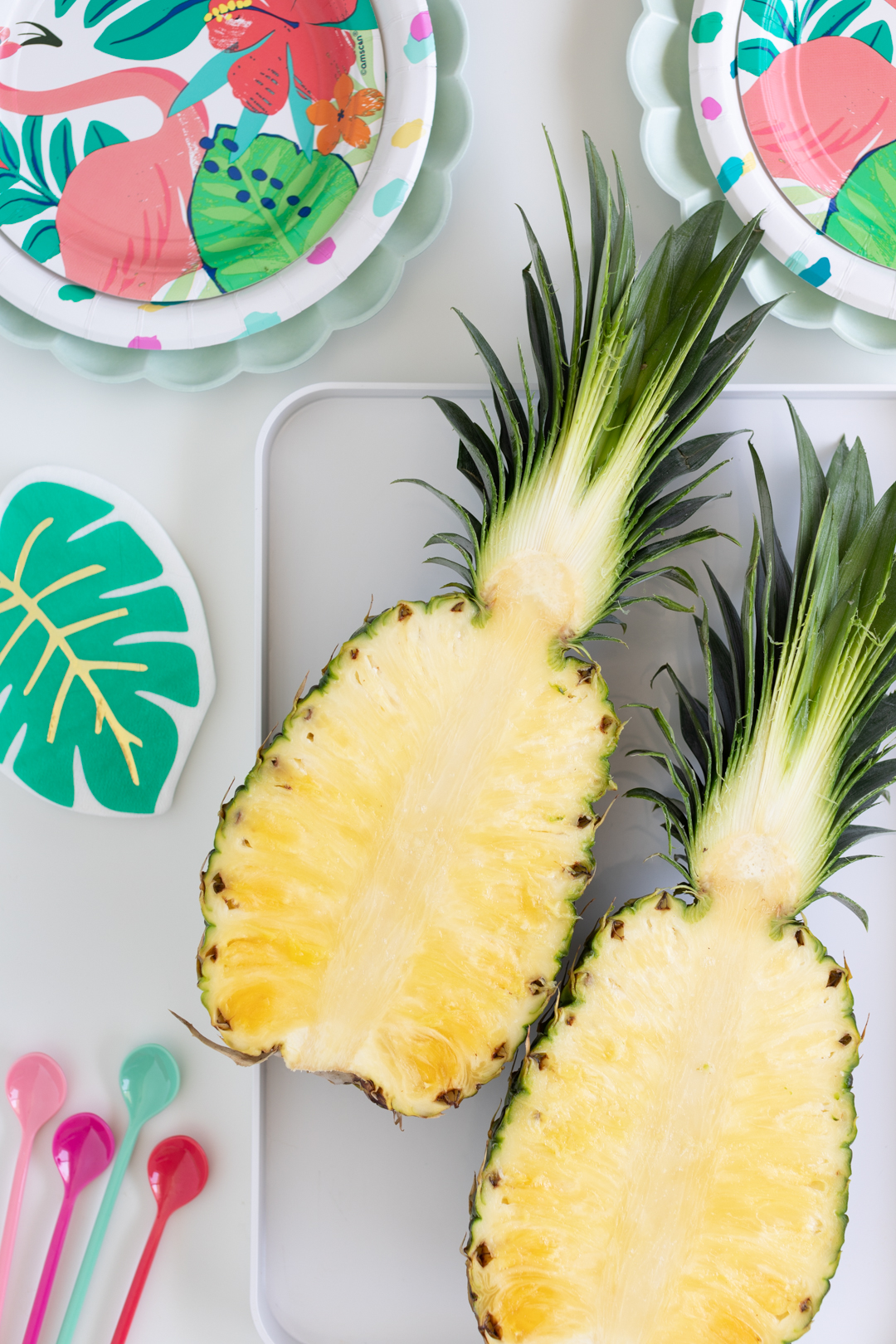 pineapple cut into two equal halves on a tray