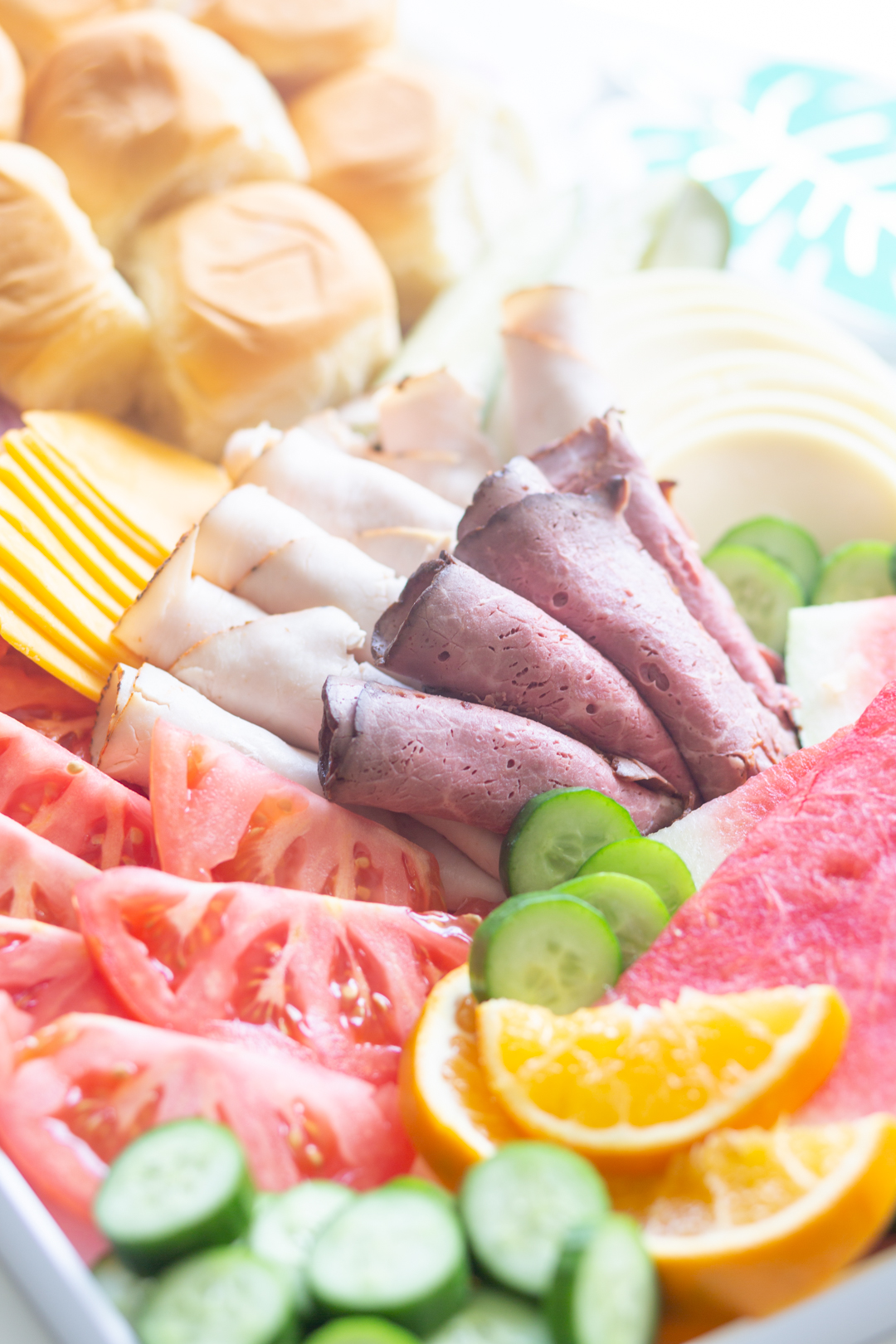 up close tray of sandwich fixings and fresh fruits