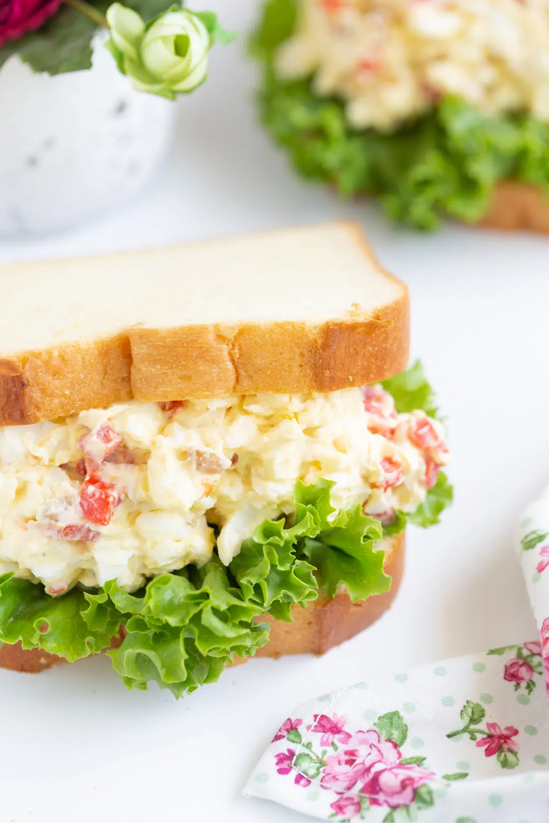 slightly angled down photo of radio sandwiches otherwise known as egg salad with pimientos and walnuts