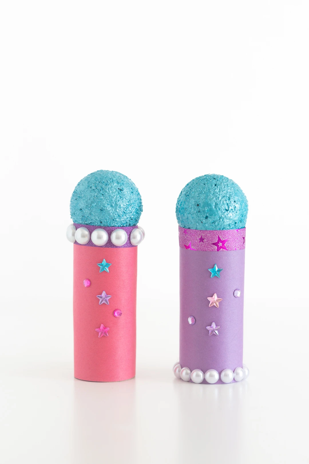two craft microphones made of toilet paper rolls, construction paper and small styrofoam balls