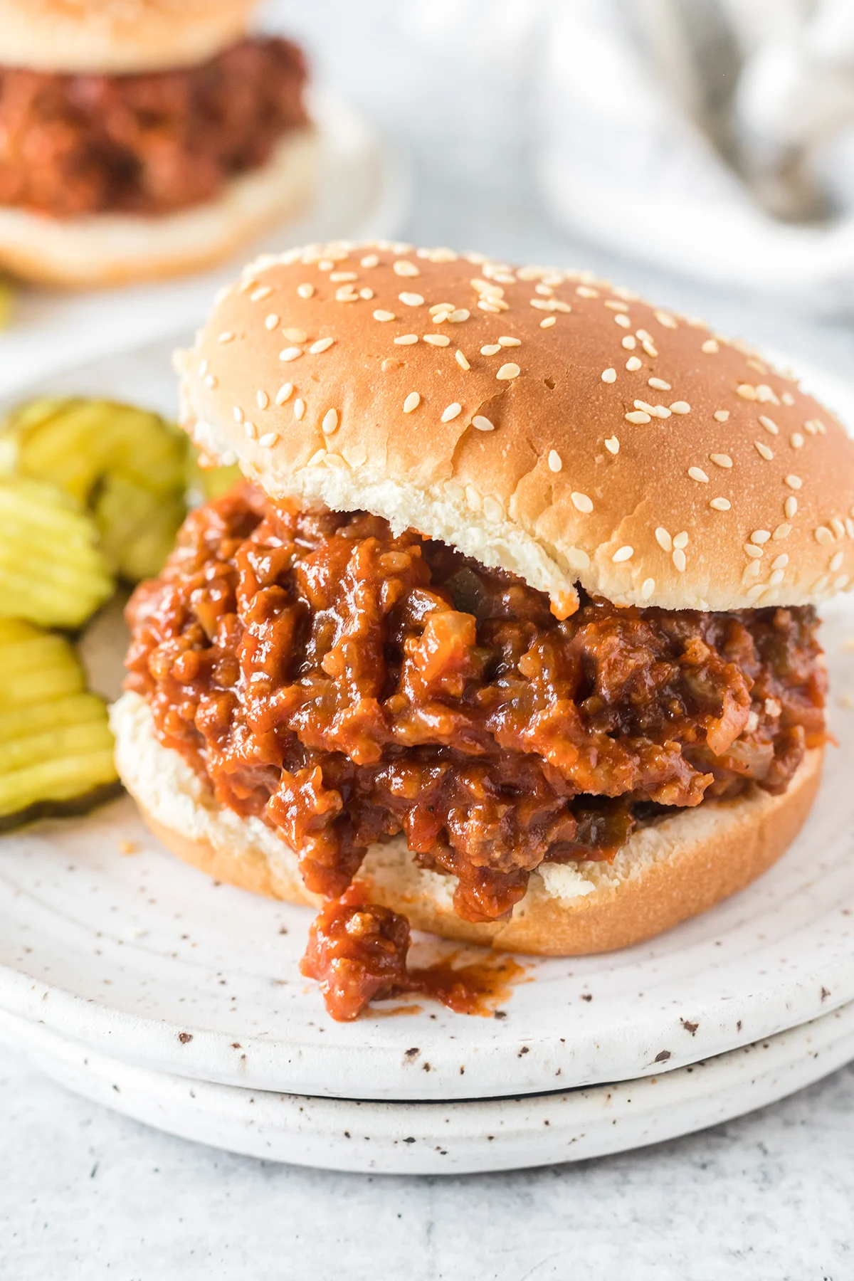 classic sloppy joe served on a sesame bun with pickles on the side