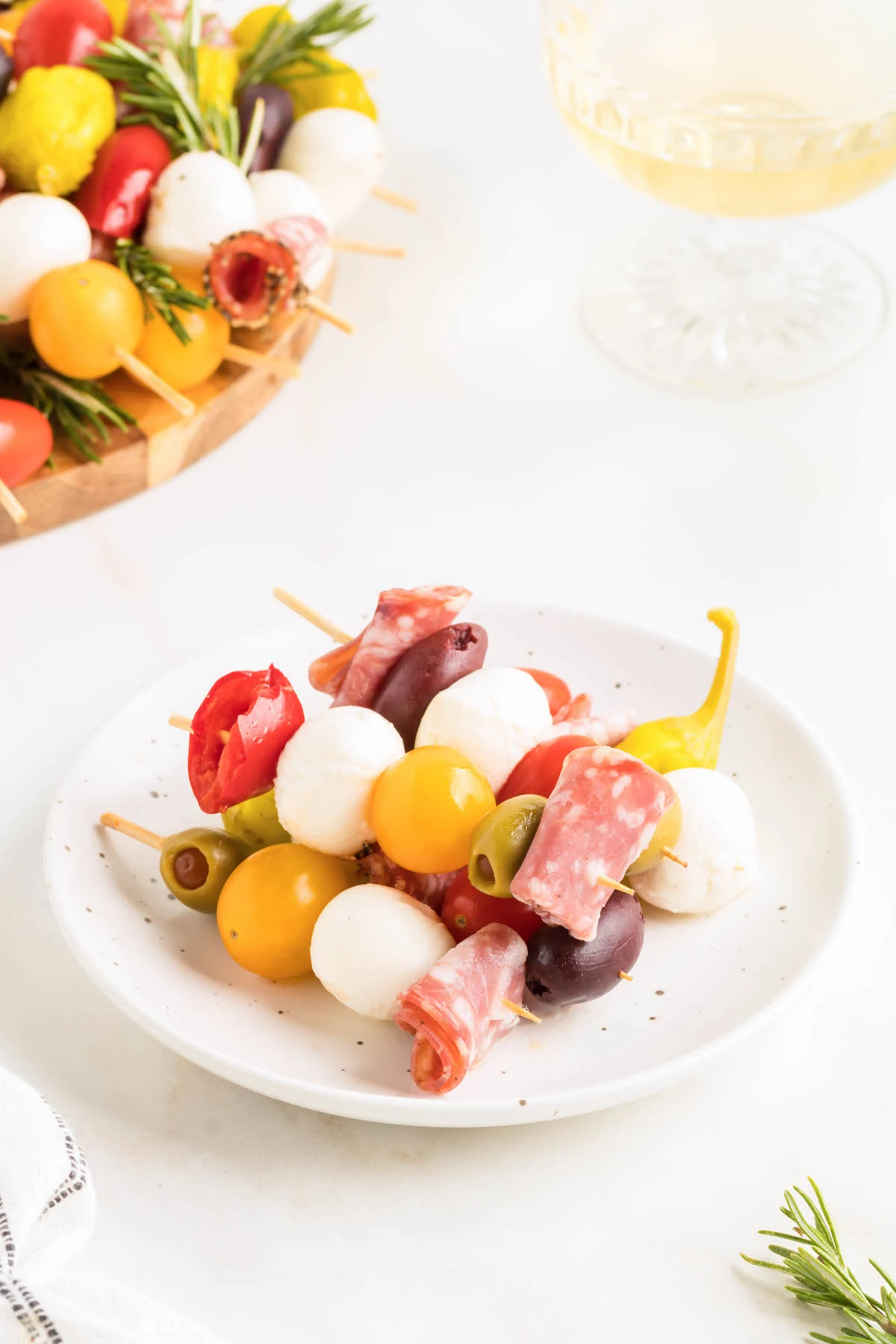 small antipasto skewers stacked on a small serving dish