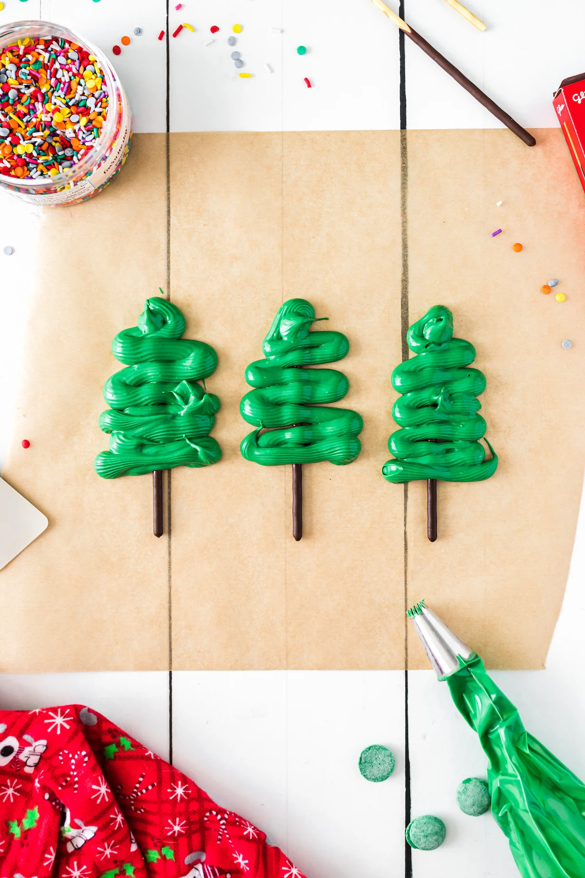making pocky christmas trees on brown parchment paper