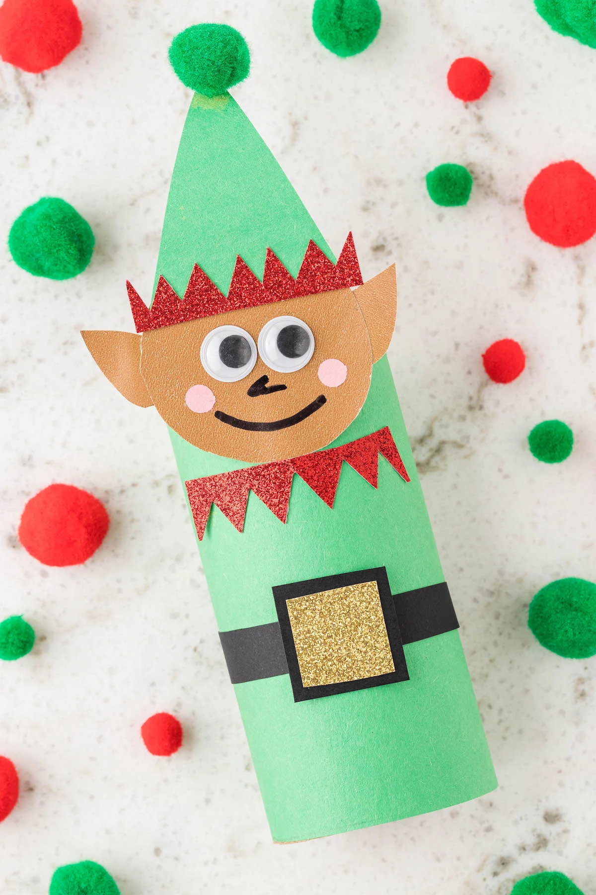 up close view of a crafted elf made of toilet paper roll and construction paper