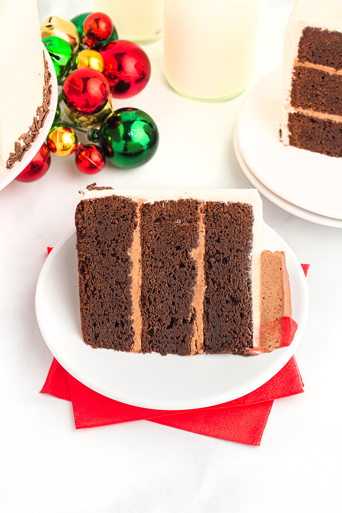 layered brownie reindeer cake slice on a plate with festive decorations in background