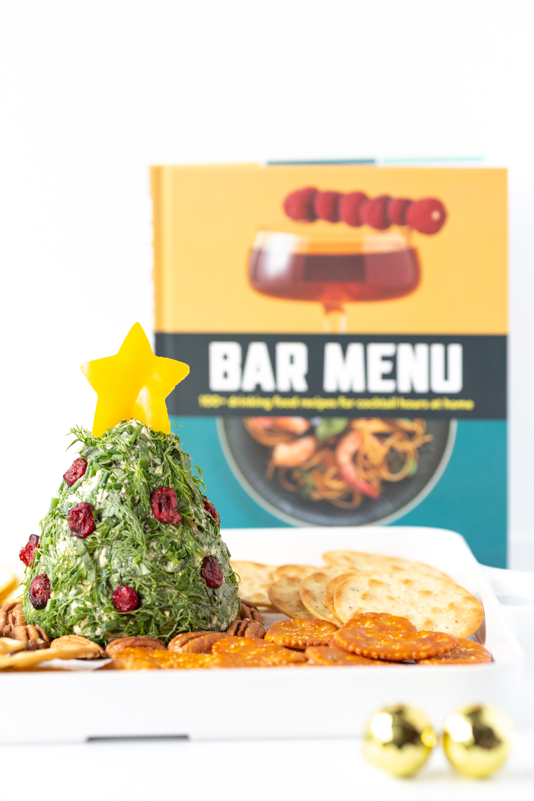 bar menu recipe book and cheese ball shaped like a christmas tree in forefront 