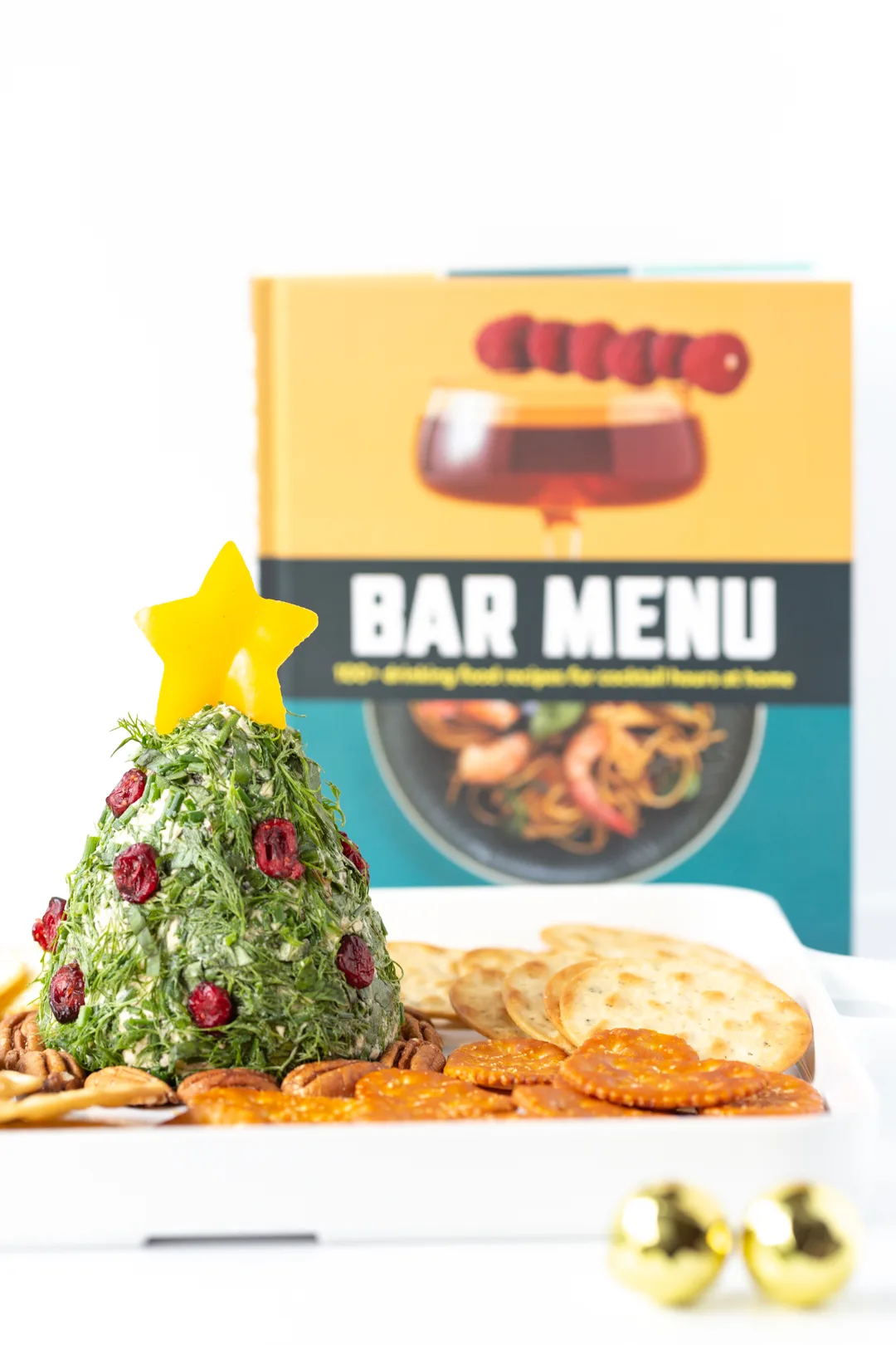 bar menu recipe book and cheese ball shaped like a christmas tree in forefront 