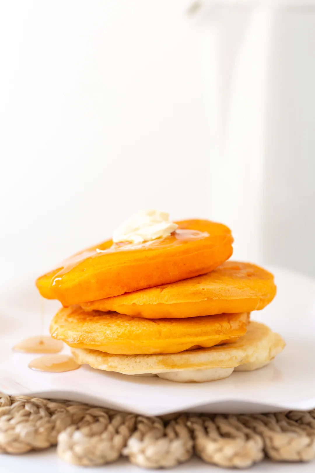 orange ombre tinted pancakes stacked onto each other