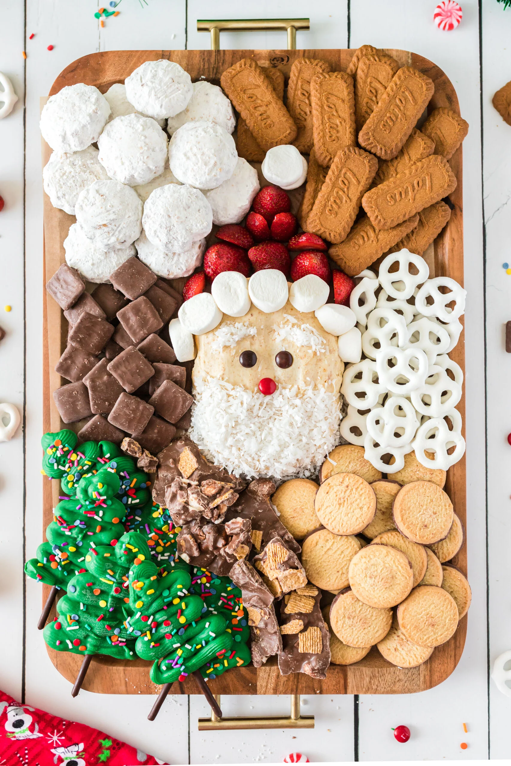 cutest santa clause charcuterie board with fun cookies to dip into a santa cheesecake ball