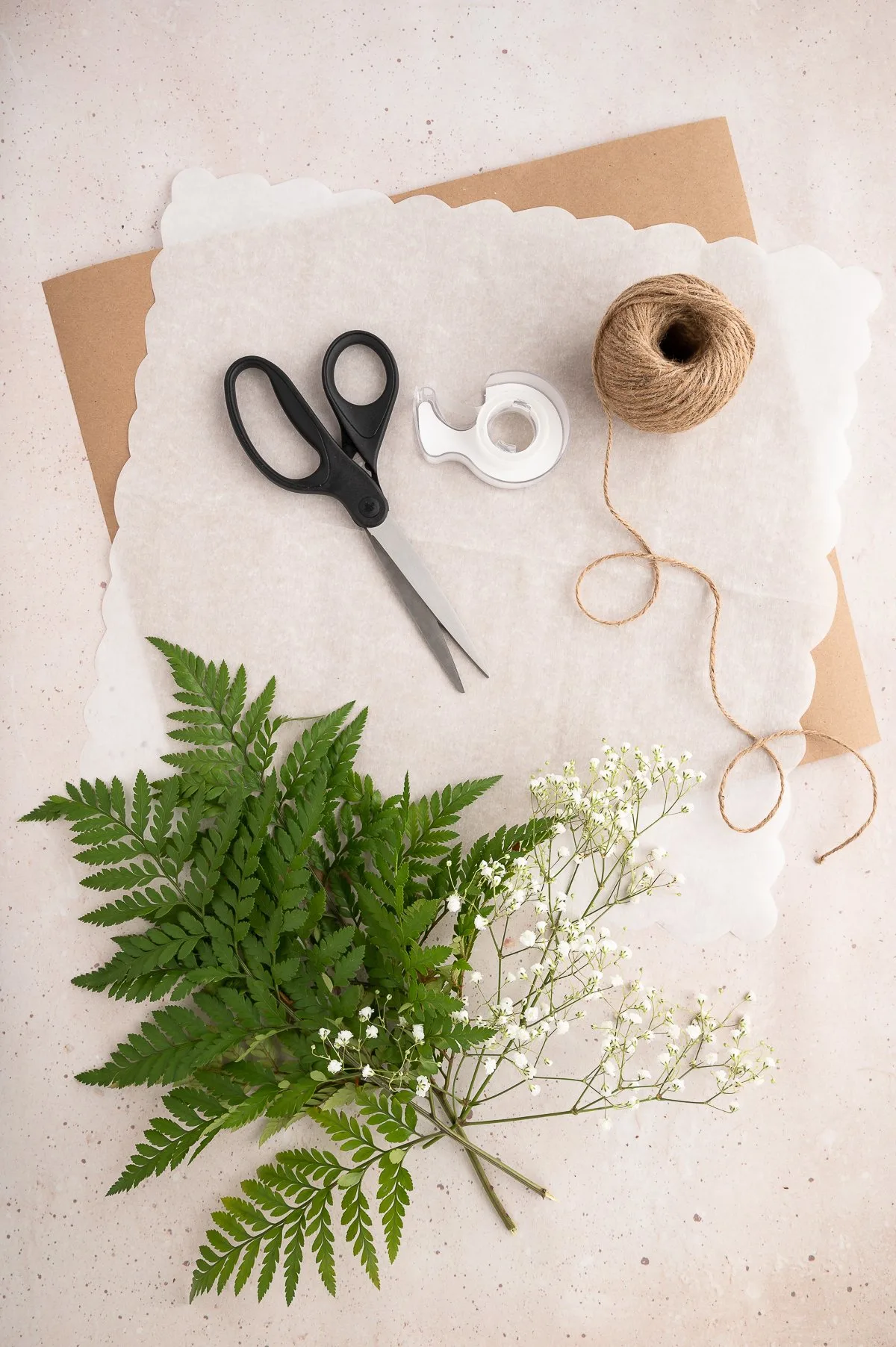 supplies needed to make an edible bouquet including scissors, twine, ferns and baby's breath.