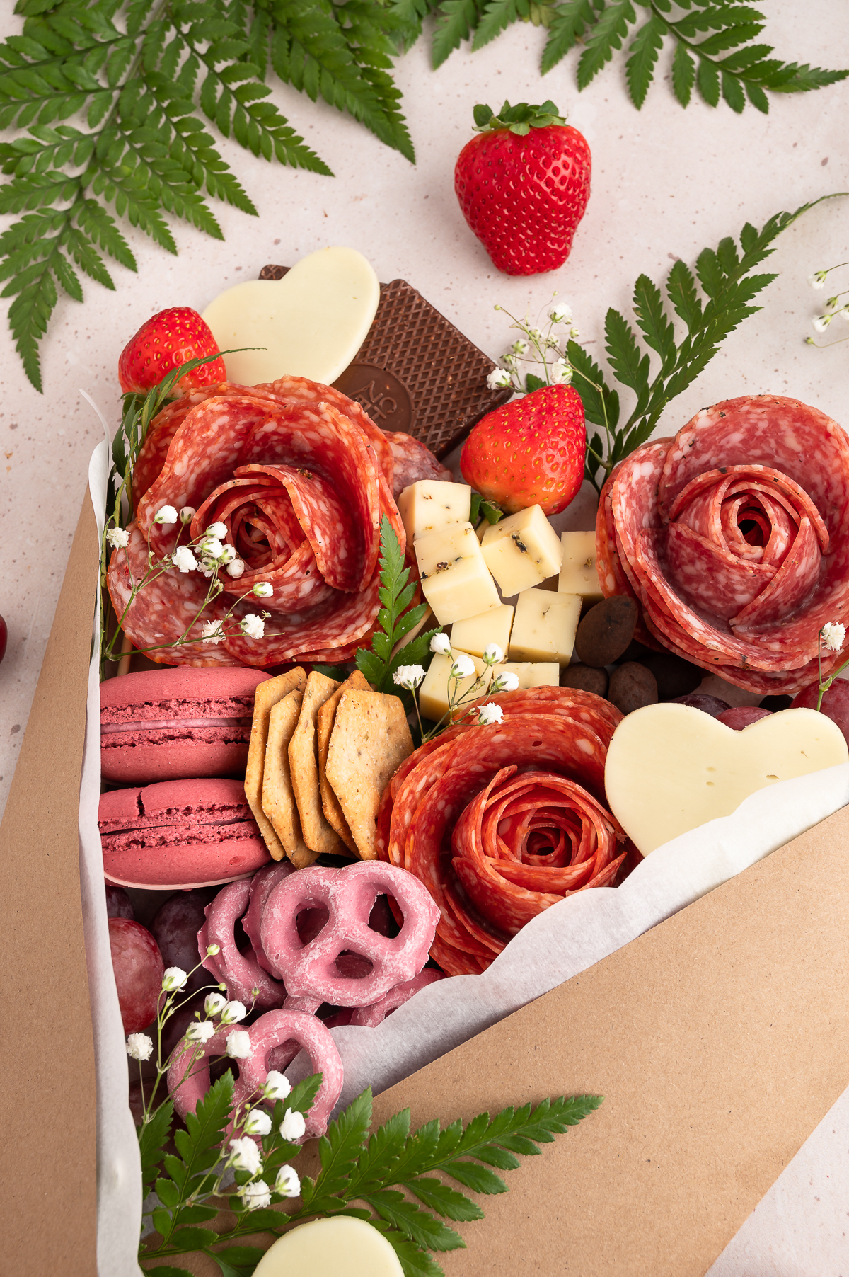 up close view of charcuterie bouquet with salami roses, cheeses, grapes, chocolates