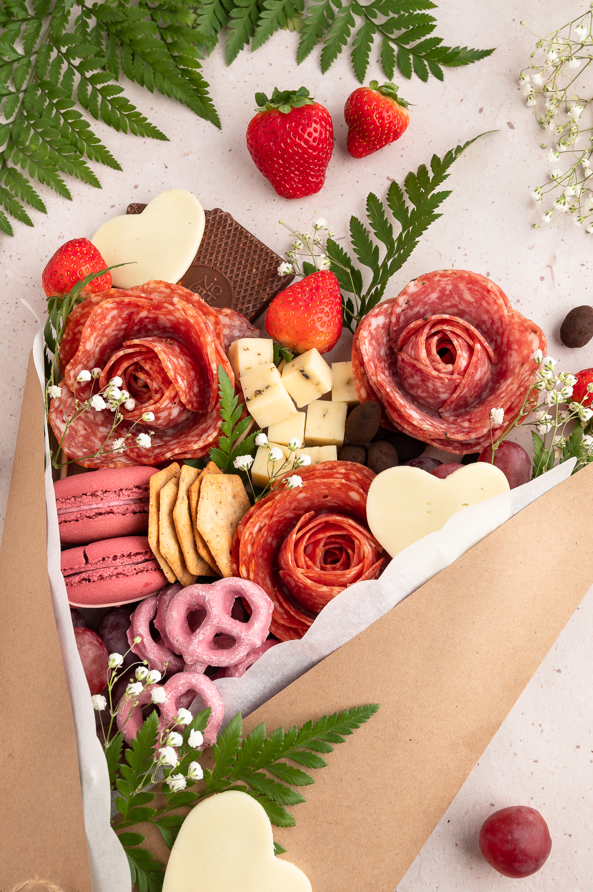 up close view of a completed charcuterie bouquet with traditional charcuterie and desserts