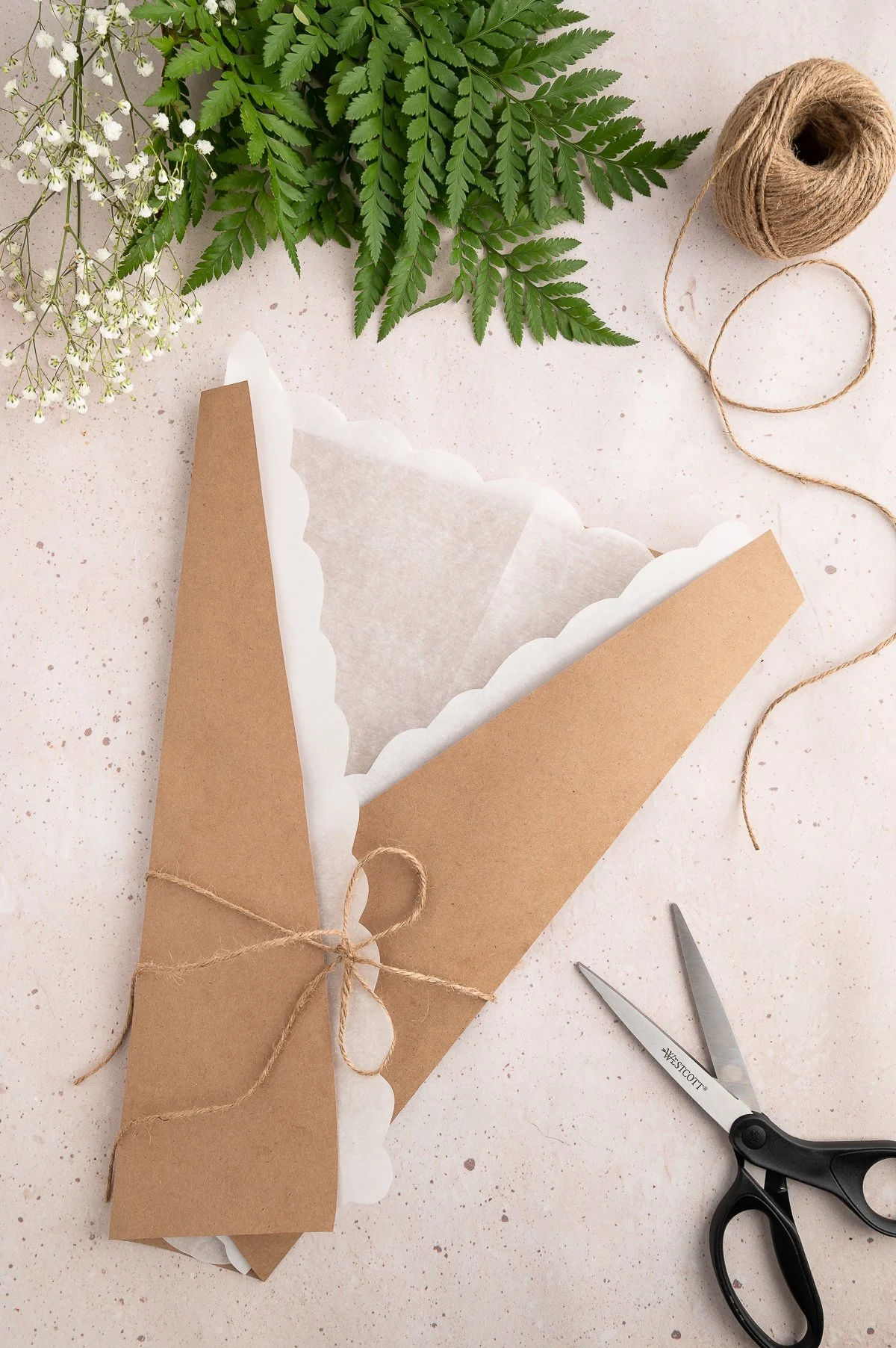wrapping kraft and parchment paper to set up to make a charcuterie board