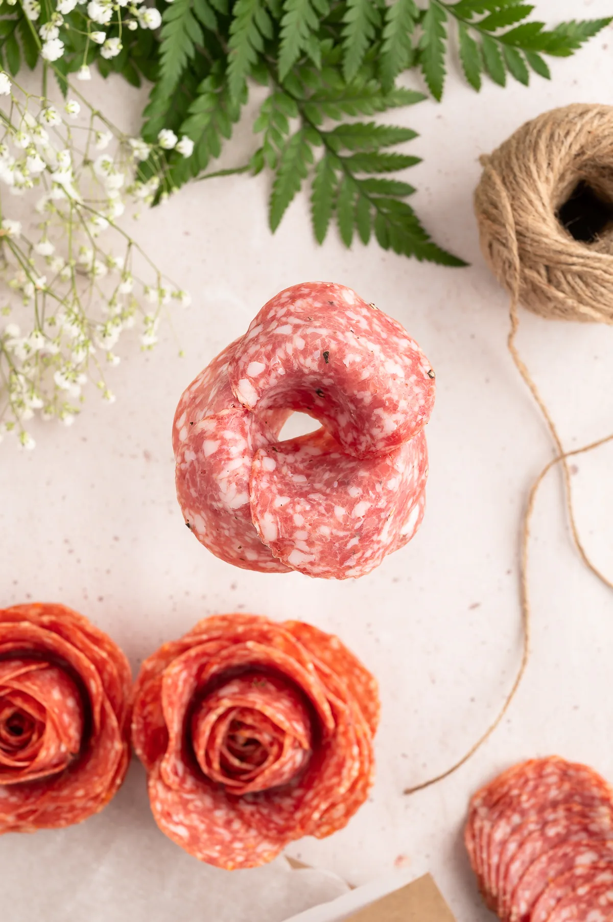 adding layers of salami to make roses with a champagne glass