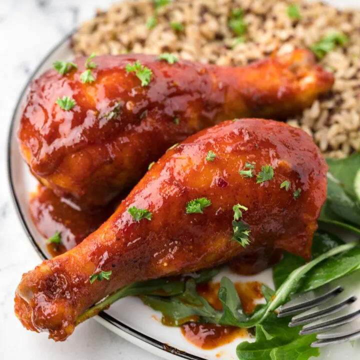 up close view of chicken drumsticks on a plate