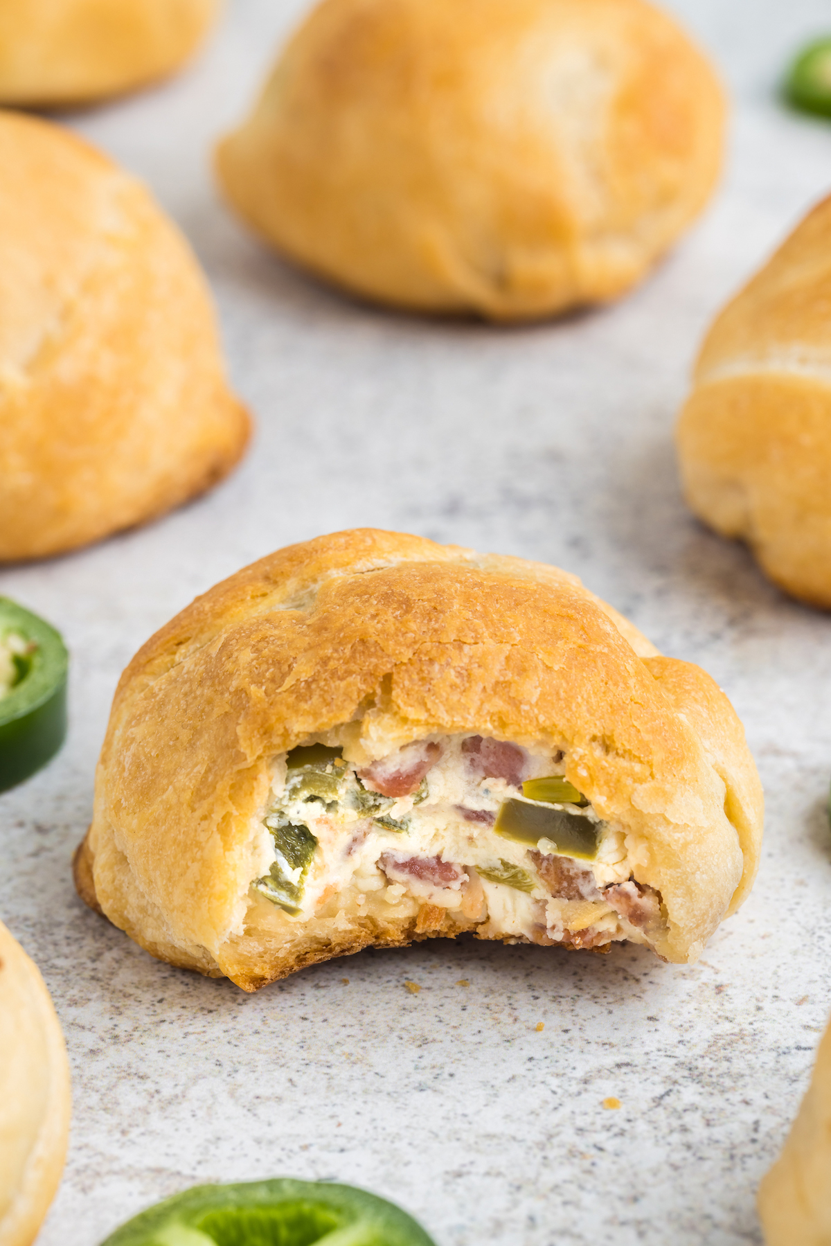 jalapeno popper with bite taken to reveal the cream cheese filling inside