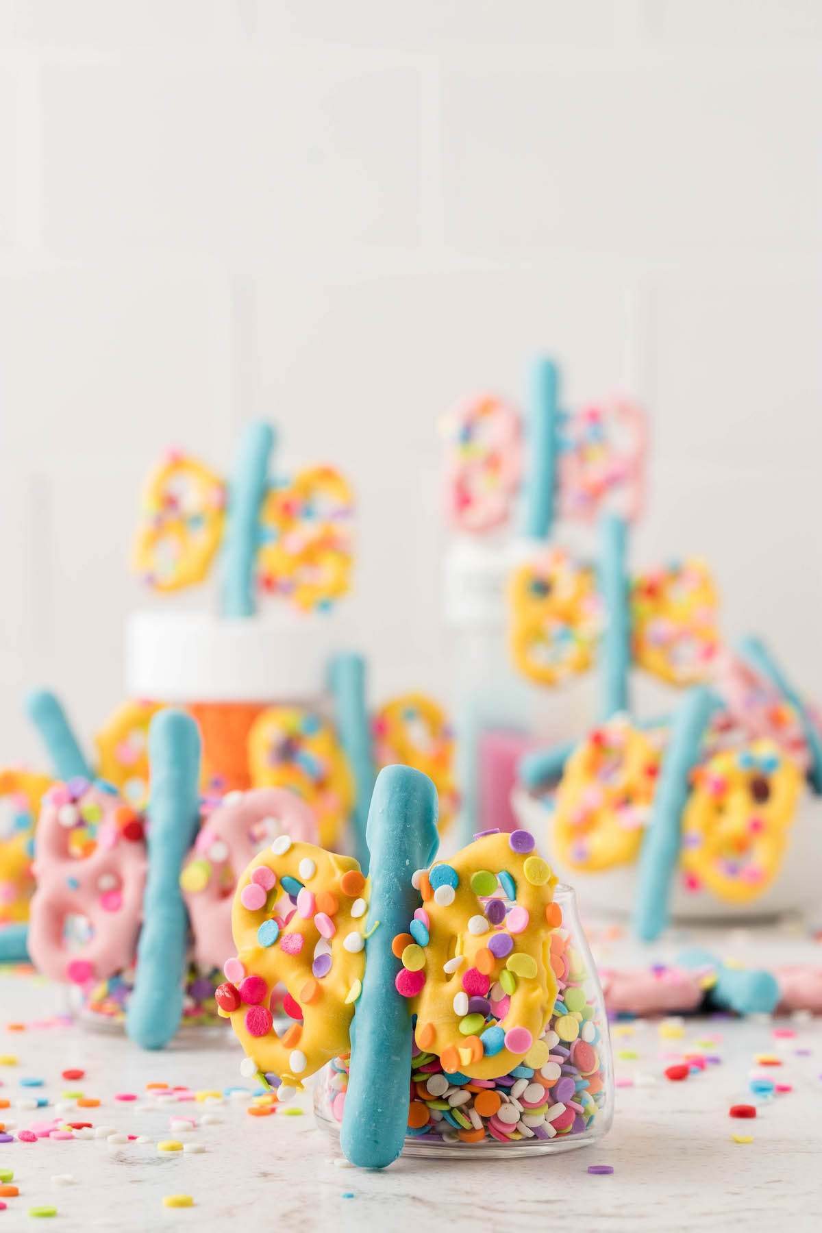 pastel chocolate butterflies resting on little jars filled with sprinkles