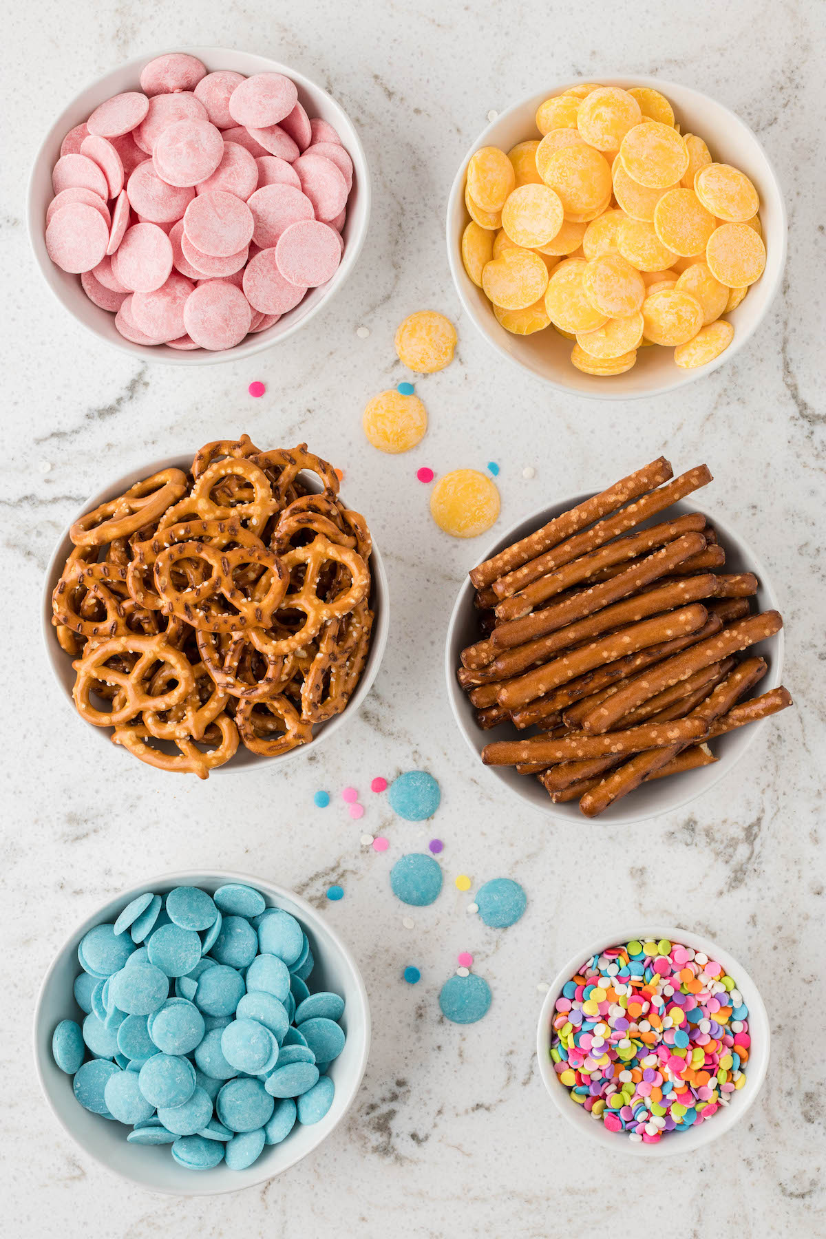 ingredients set out in bowls to make pastel chocolate butterfly pretzels