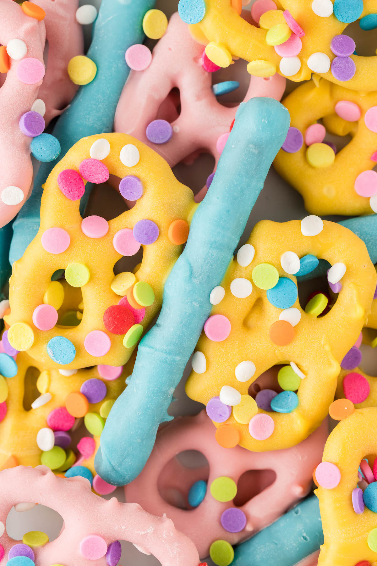 very up close view of chocolate butterfly pretzels with sprinkles on it.