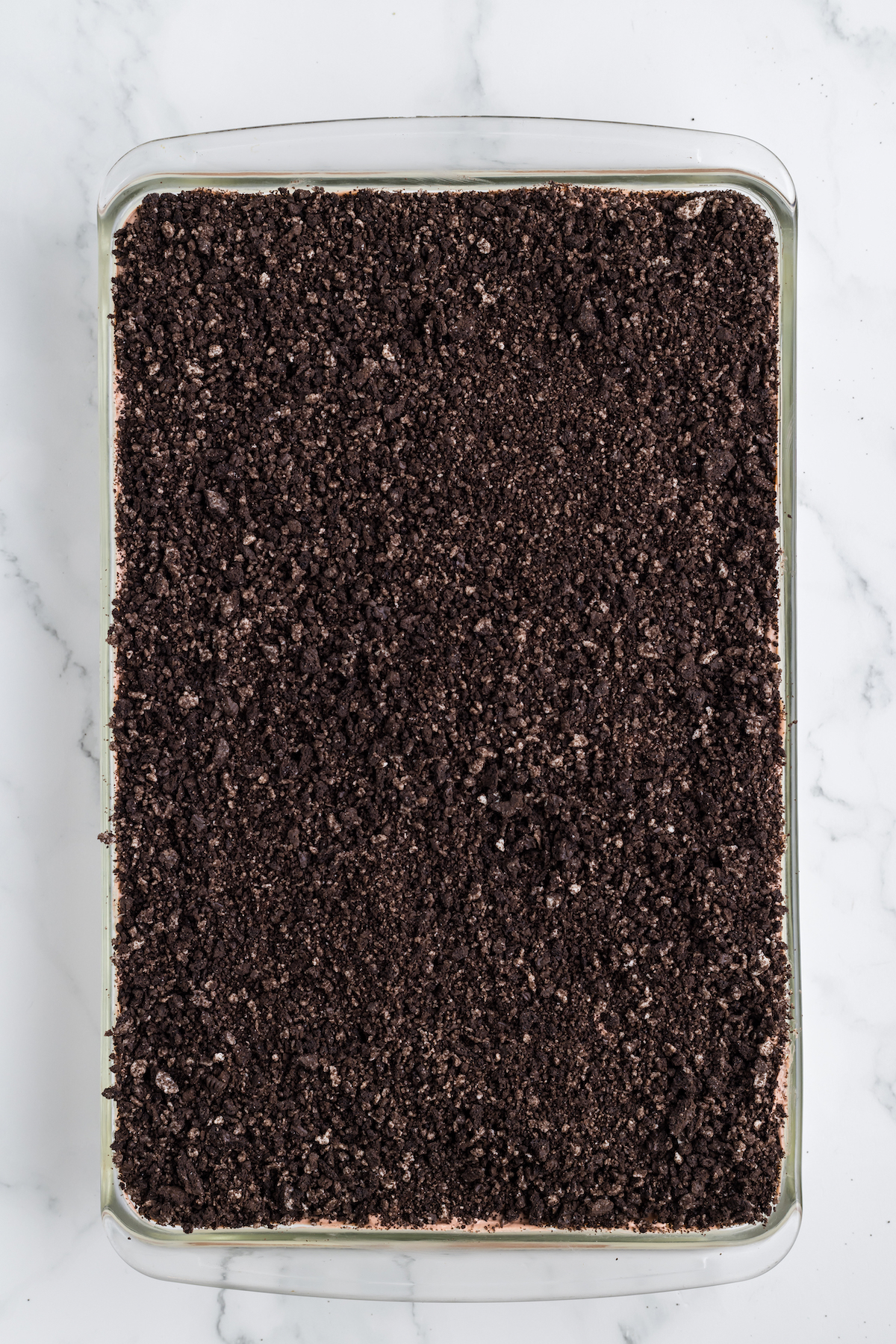 crushed oreo cookie layer for dirt cake, overhead view