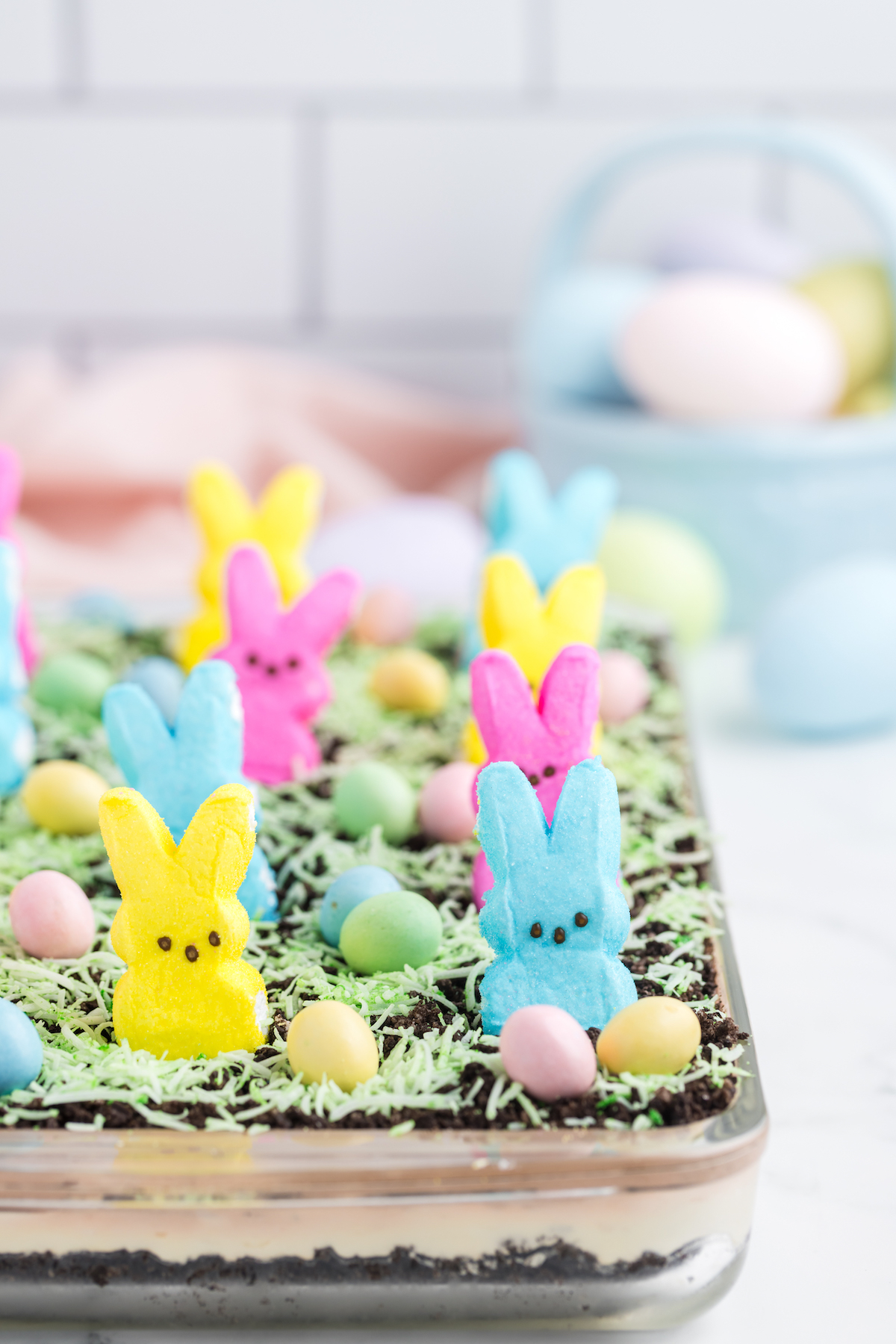 peeps dirt cake with decorative easter basket in background