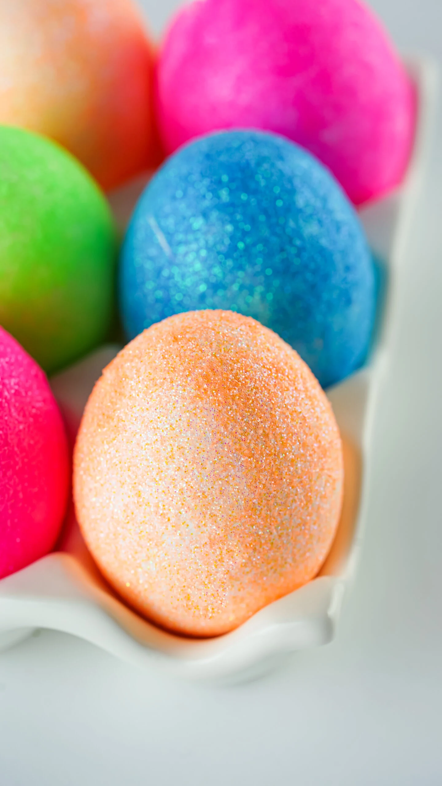 angled down view of variety of glittery easter eggs
