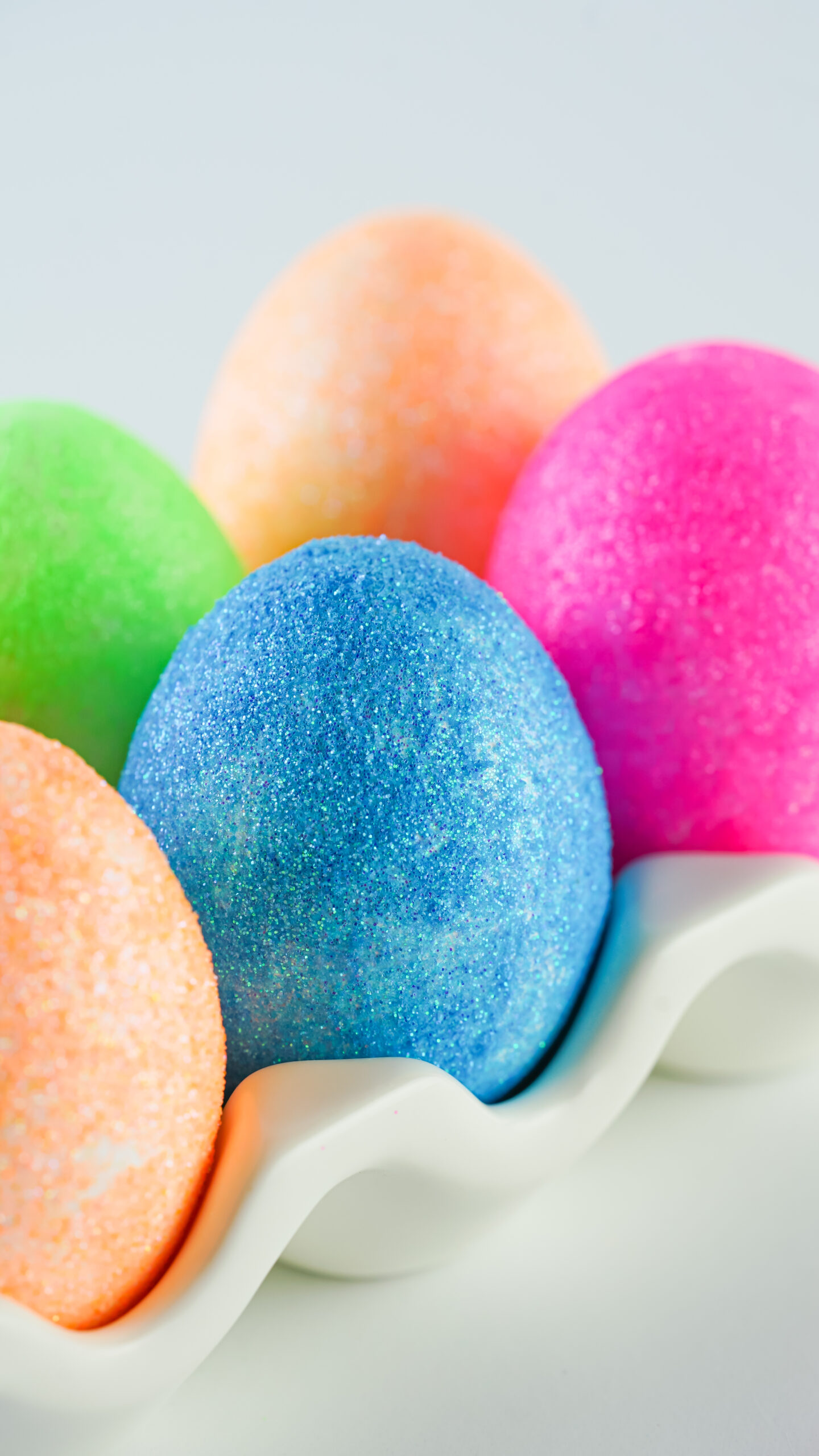 glitter easter eggs in an egg holder
