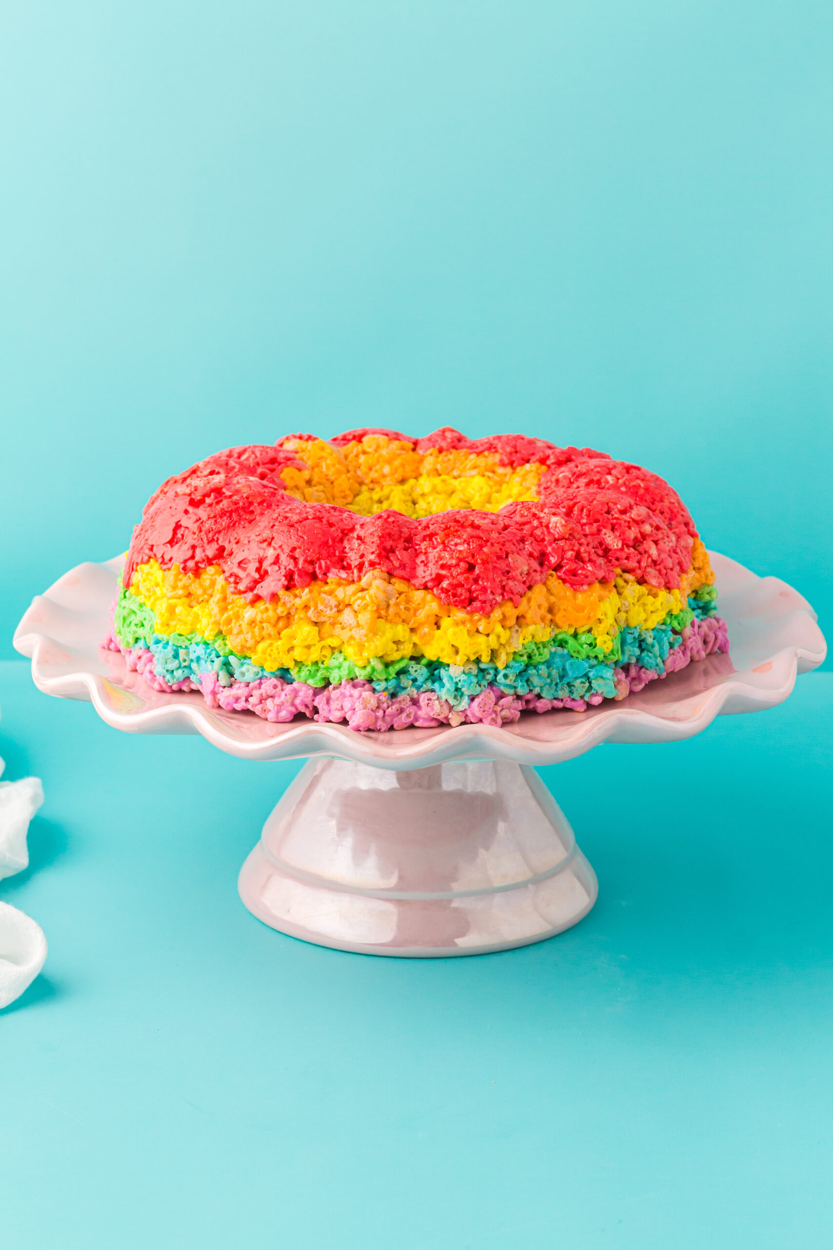 pretty rainbow bundt cake made using rice krispies cereal