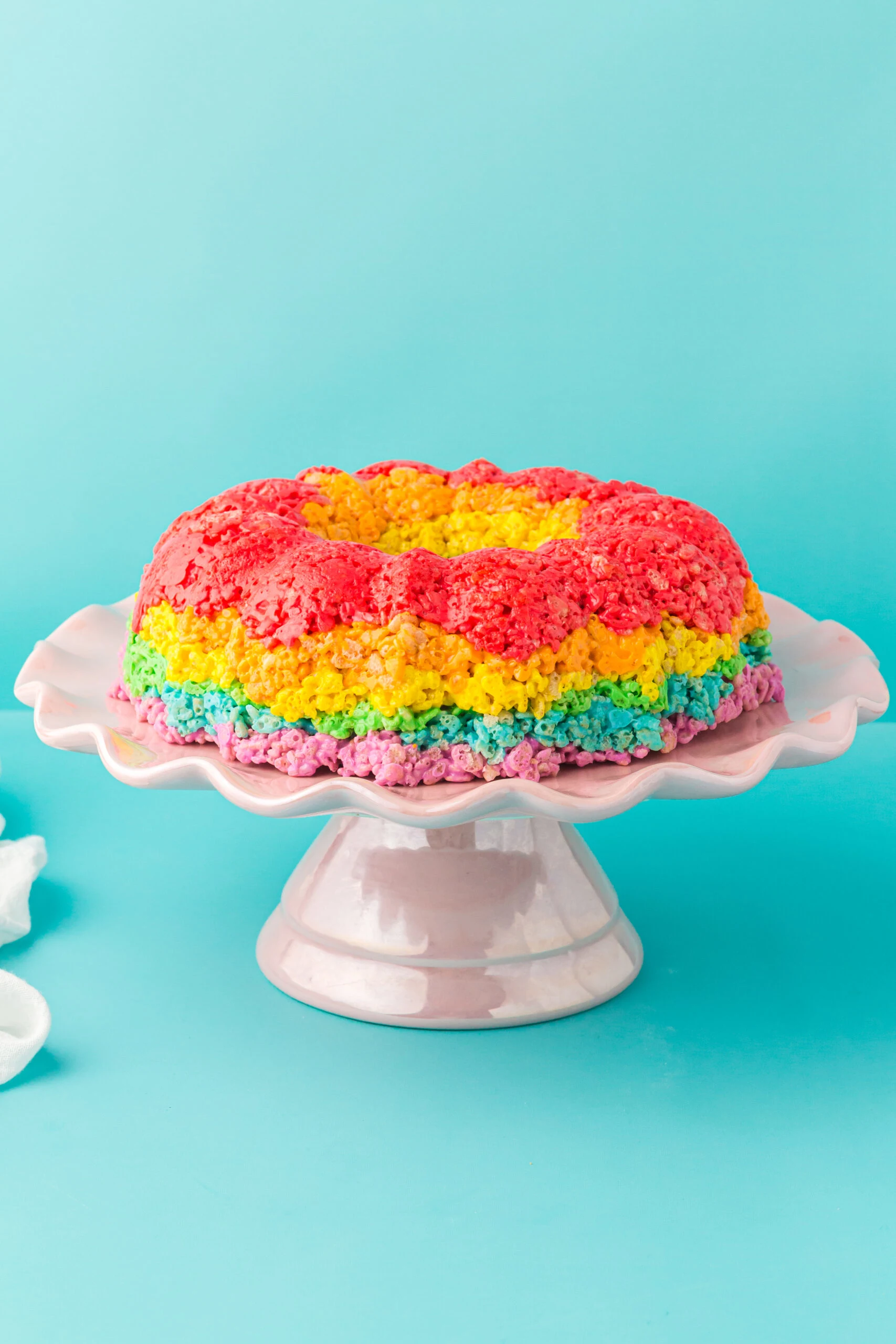 pretty rainbow bundt cake made using rice krispies cereal